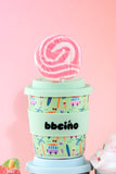 Colorful cup with a pattern on a pink background
