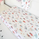 Fitted sheet with fairy and floral pattern on a crib