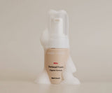 Perineal foam bottle labeled 'Bare Mum' on a beige background