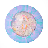 Round container with colorful marbled rim filled with small toys and beads on a white background