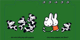 Cartoon character Miffy playing with puppies on a green background