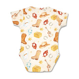 A short-sleeve baby bodysuit with a western-themed print featuring cowboy boots, hats, guitars, horseshoes, bandanas, and stacked hay bales on an off-white background.