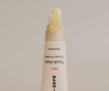 Bare Nipple Balm tube with visible cream on beige background