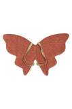 Butterfly-shaped object with a textured surface on a white background