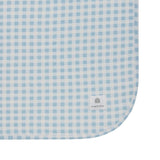 Blue and white checkered fabric with a brand logo on a white background