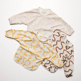 Two baby rompers with wavy pattern on a white background