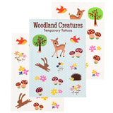 Three sheets of woodland-themed temporary tattoos fanned out behind a central package card. The designs include a deer, rabbit, hedgehog, mushrooms, flowers, birds, and trees on a white and pale blue background.
