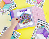 A hand with red nail polish holds an open colorful sticker book on a bright yellow background, surrounded by scattered sticker sheets with cartoon illustrations and text like 'SPECIAL STICKERS' and 'TINYTOWN PIPETECH'.