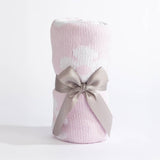 Pink textured blanket with a gray ribbon on a white background