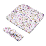 A baby swaddle blanket and matching knotted headband set, both featuring a delicate multicolor floral print on a white background, shown on a clean white studio background.