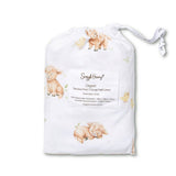 A folded white organic cotton baby change pad cover by Simply Huany, featuring a watercolor print of sheep, chicks, and a cow, shown inside its drawstring storage bag with a product label on a white background.