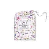 A packaged cotton pillow cover with a white background and a colorful floral print, featuring a white drawstring bag with a product label from 'Simply House'.