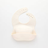 Beige silicone bib on a white background