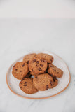 Plate of chocolate chip cookies on a white surface