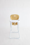 High chair with a yellow checkered cushion on a white background