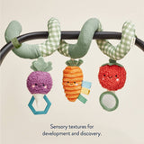 Spiral toy with colorful vegetables on a beige background