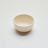 White ceramic bowl on a light gray background