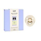 BIBS pregnancy surprise box with a baby pacifier on a white background