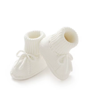 Pair of white knitted baby booties on a white background