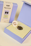 BIBS baby product packaging with a purple box and yellow interior