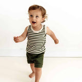 Child wearing a striped tank top and shorts on a white background
