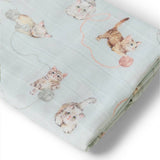 Folded fabric with cat pattern on a light blue background