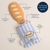 Baby teething toy with bread design and crinkle bag on a beige background