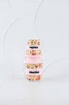Stack of colorful baby bottles with 'bebeino' branding on a light gray background