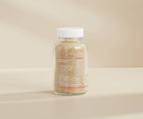 Glass jar with a white lid on a beige background