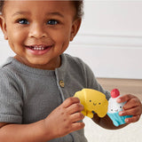 Child holding two colorful bath toys, one yellow and one blue, against a neutral background.