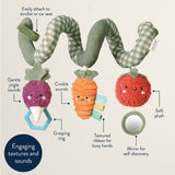 Baby toy with colorful vegetables and text describing features on a beige background