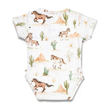 A short-sleeve baby bodysuit with a desert landscape print featuring brown horses, green cacti, beige mountains, and a white background.