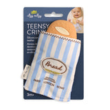 Baby teether shaped like a bread roll in striped packaging with 'itzy ritzy' branding.