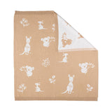 Baby blanket with white animal patterns on a beige background