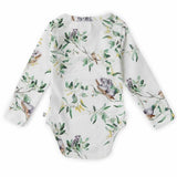 Baby onesie with nature-themed print on a white background