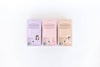 Three small boxes with different colored covers on a white background