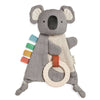 Gray koala plush toy with a ring and colorful strips on a white background