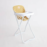 White high chair with yellow checkered cushion on a light gray background