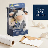 Bitzy Pal plush toy in packaging with gift wrapping supplies on a light background