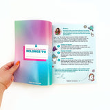 Open book with colorful cover and text held by a hand on a white background