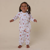 Child wearing a floral pajama set on a beige background