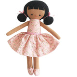 Toy doll with a pink floral dress on a white background