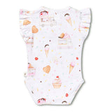 A white baby bodysuit with ruffled sleeves and a playful ice cream and dessert print, laid flat against a clean white background.