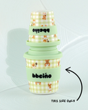 Stack of green and yellow checkered cups with 'bbeino' branding on a white background