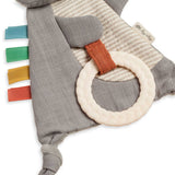 Textile teething ring with colorful straps on a white background