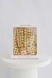 Yellow and white checkered baby doll wearer in a Tiny Harlow box on a white surface with a light gray background.