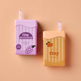 Two small containers, one purple and one orange, with 'tiny tummies' branding on a beige background.
