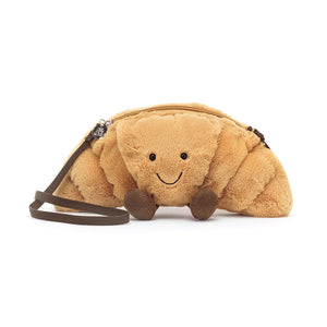 Plush toy shaped like a caterpillar with a smiling face on a white background
