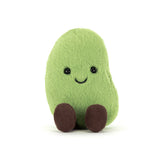 Green plush toy with a smiling face on a white background