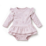 Pink baby dress with ruffled sleeves and bottom on a white background